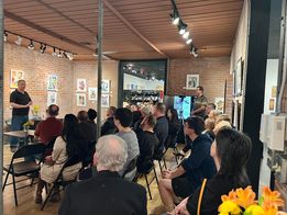 Guests listening to Dave Hughes speak about Maybe Next Year and Instant Adult