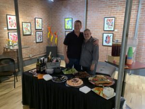 Exposed Studio & Gallery owner Gregg Edelman and Dave Hughes at food table.
